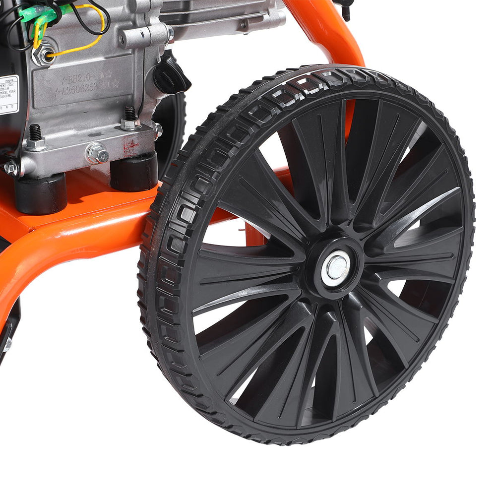 Close-up of large black wheel and nearby engine mounting of pressure washer.